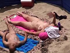 Mature women enjoy the sun and each other on the beach