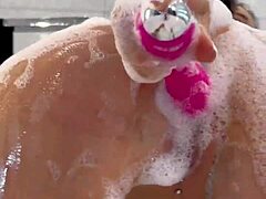 Monika Fox gioca con un giocattolo rosa in un bagno schiumoso