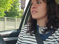 Solo masturbation of a slender brunette in the car